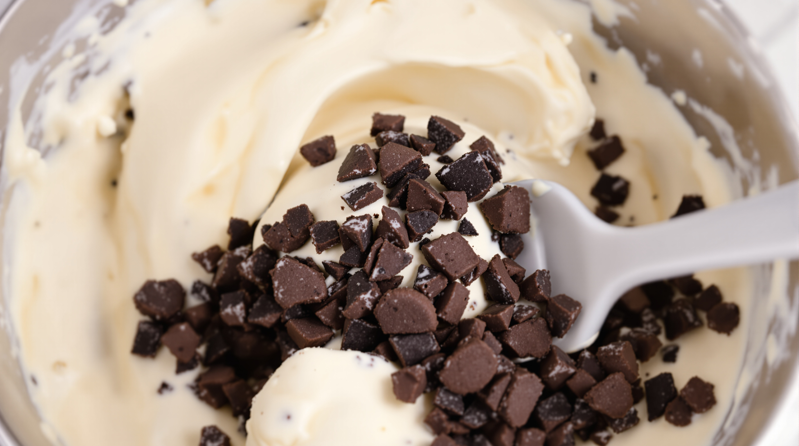 Folding cookie pieces into ice cream base